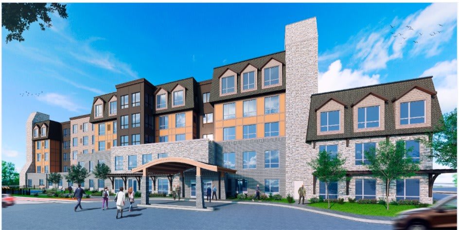 Modern hotel building with an inviting entrance and people gathered outside.