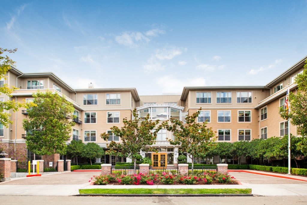 A modern residential building with landscaped gardens and a welcoming entrance.