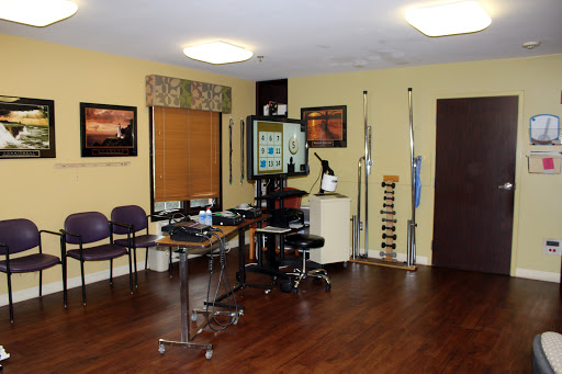 A well-organized medical office waiting area equipped with chairs and tables, featuring a calming color scheme.