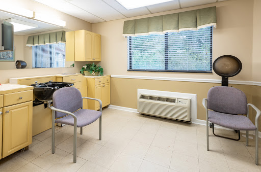 A clean and modern waiting room with simple furniture and natural light.