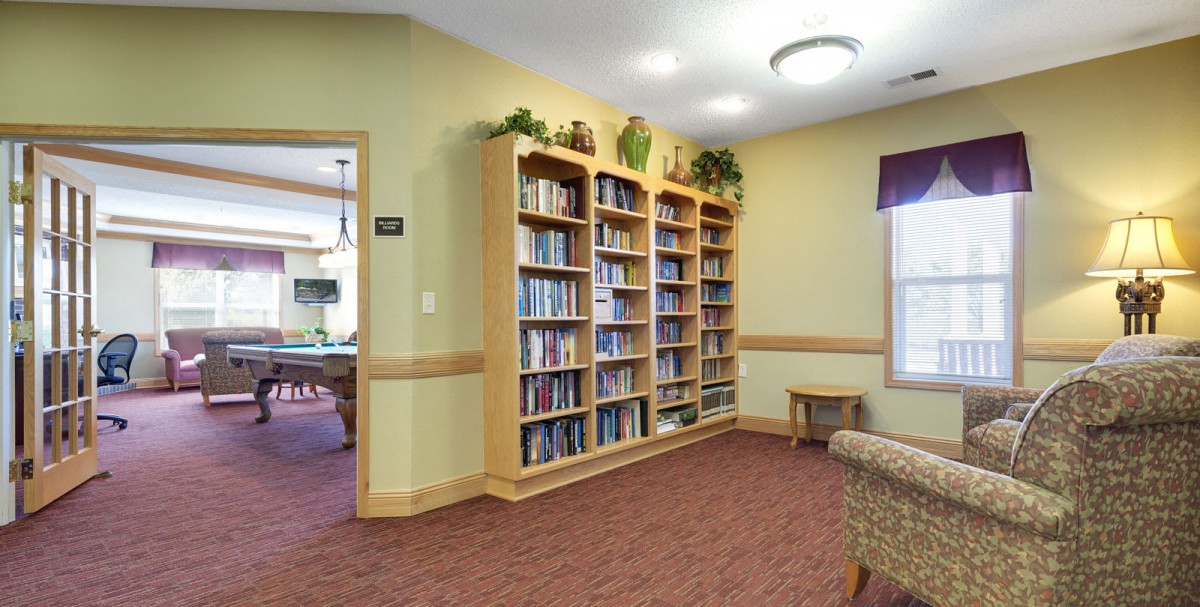 A cozy reading room with bookshelves filled with books.