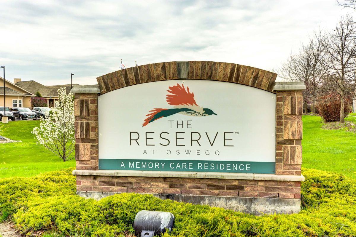 The Reserve at Ravenwood - A Memory Care Residence sign surrounded by a brick structure.