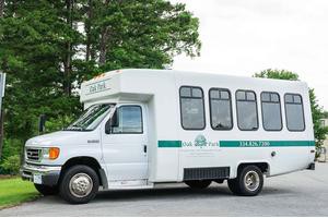 A white shuttle bus parked outdoors.