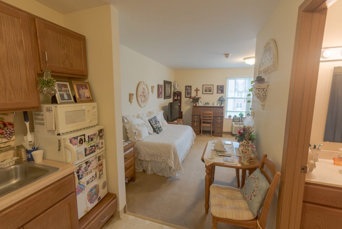 A cozy and well-decorated bedroom with wooden furniture and various decorations.