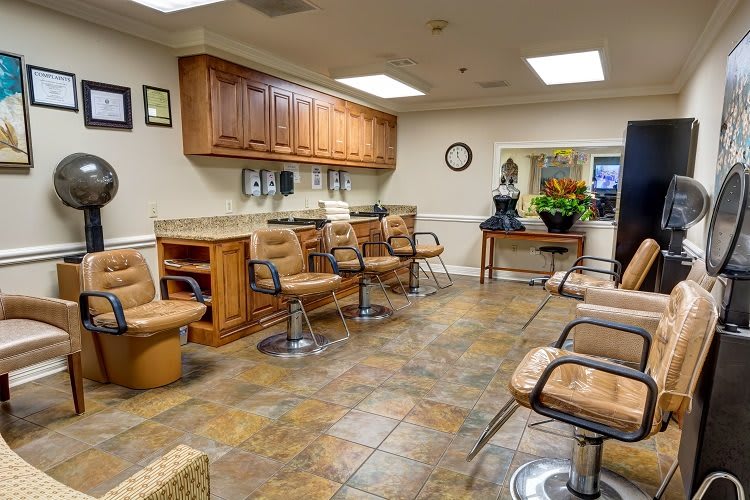 Interior view of a hair salon with chairs and mirrors.