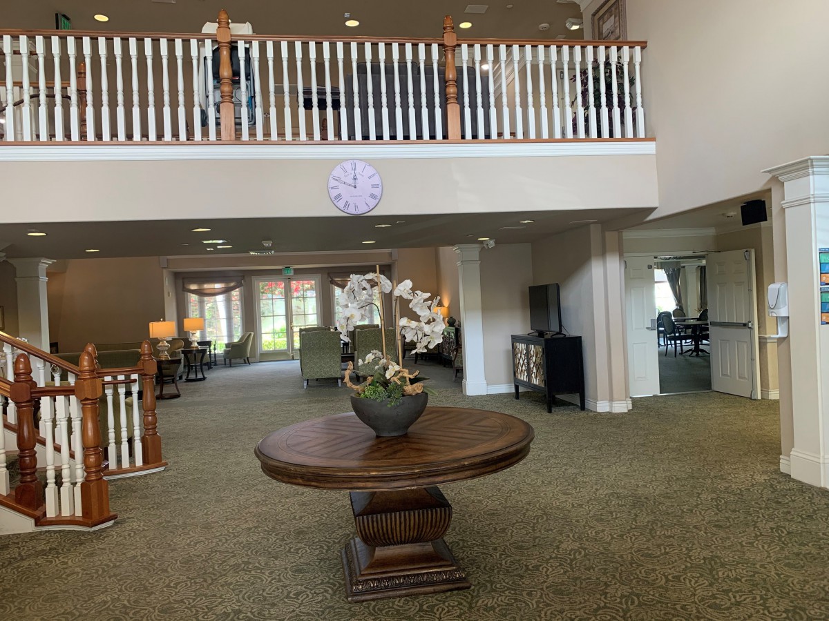 A spacious lobby area featuring a central table with floral decoration.