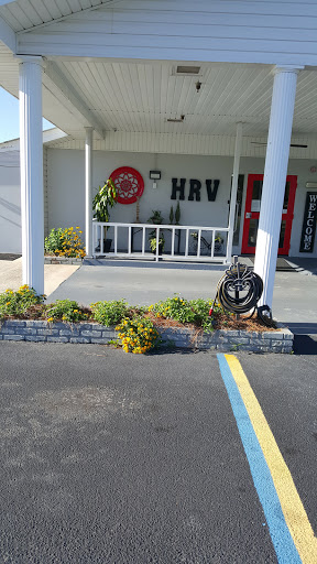 A welcoming entrance featuring landscaped greenery and a prominent sign.