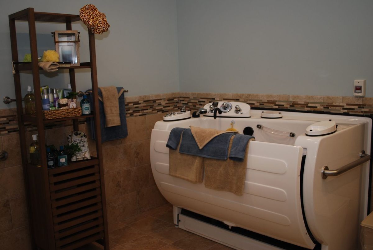 A cozy bathroom with a modern bathtub and neatly arranged towels.