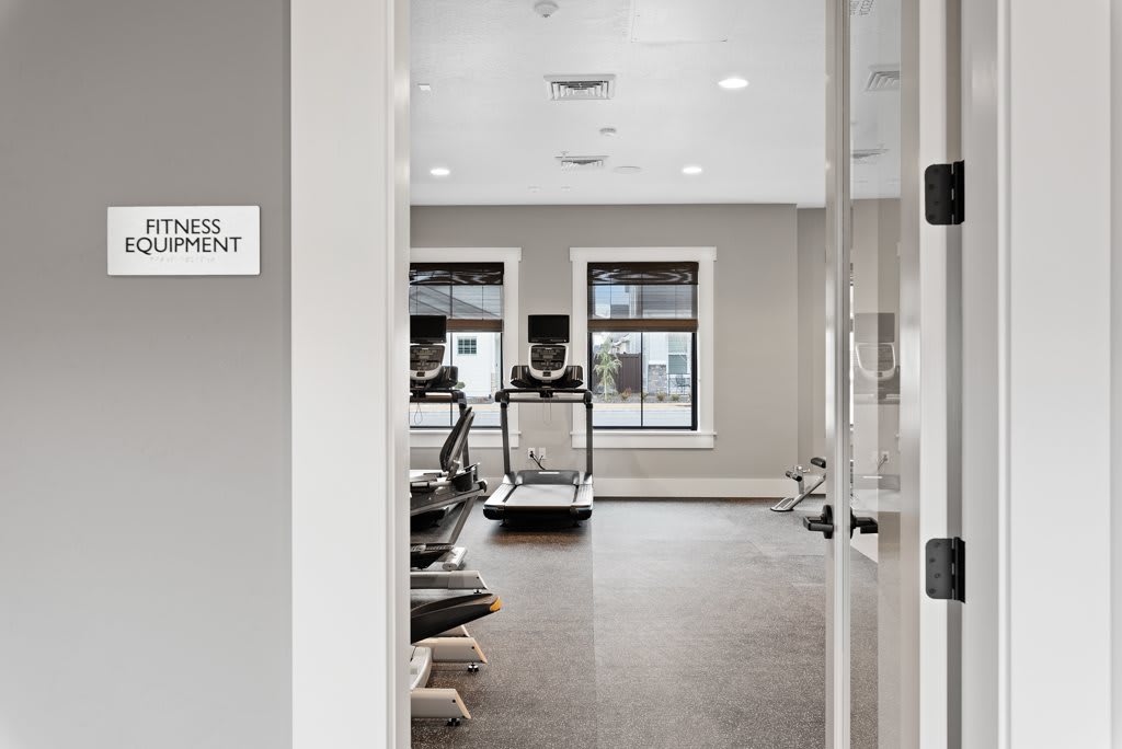 A modern gym with treadmills and fitness equipment.