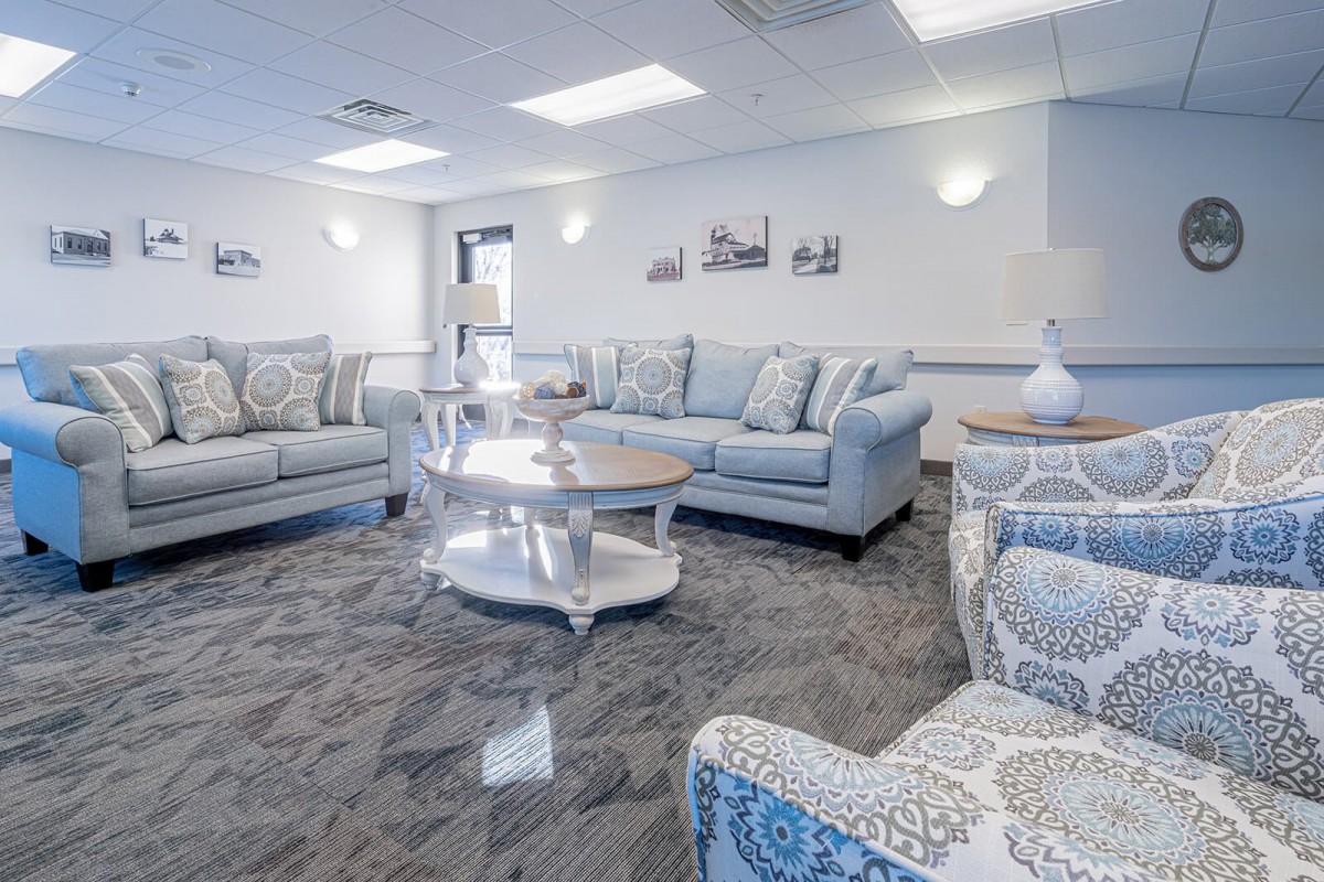 A modern living room with stylish sofas and a central coffee table.