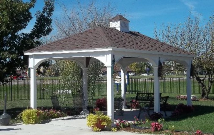 A scenic outdoor gazebo in a garden setting.