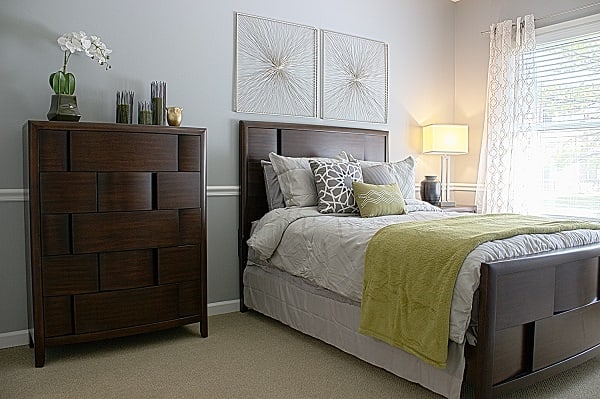 A cozy bedroom with elegant decor and a neatly made bed.