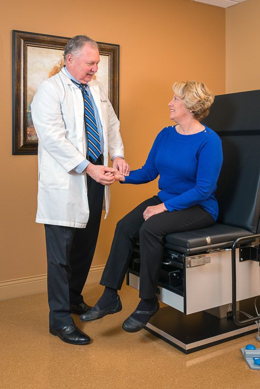 A doctor consults with a patient in a medical exam room.