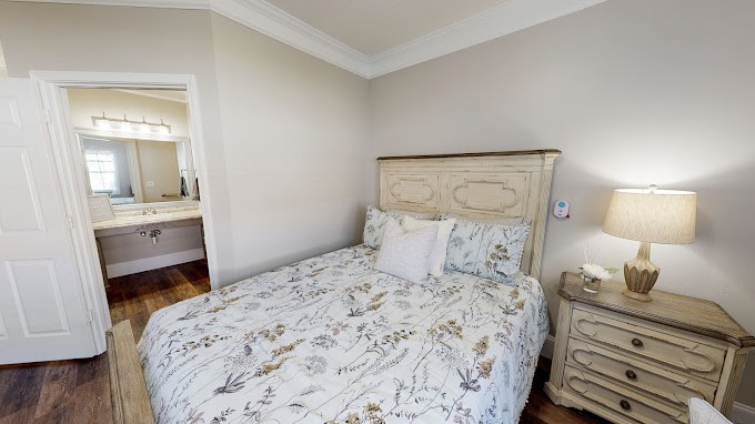 A cozy bedroom with floral bedding and matching furniture.