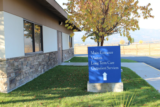 A sign indicating the location of health and long-term care services at a facility.