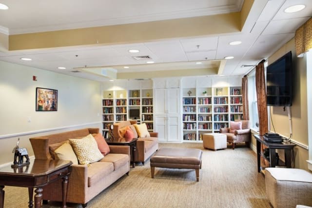 A cozy library reading area with sofas and bookshelves.