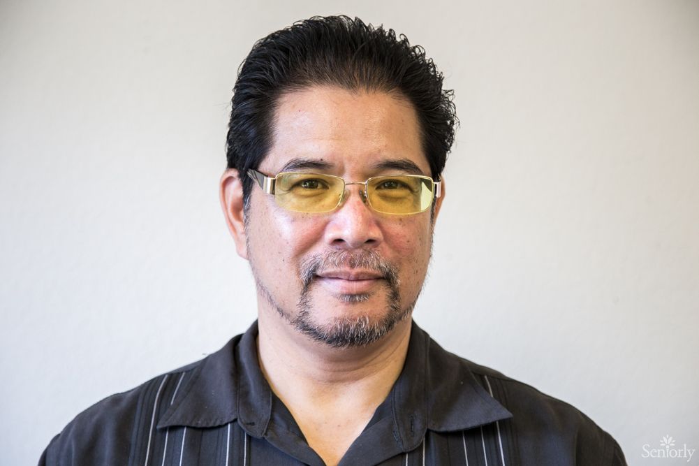 A portrait of a man wearing glasses with a neutral expression.