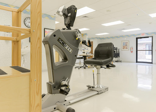A modern optometry examination setup, featuring specialized medical equipment and a comfortable patient chair.