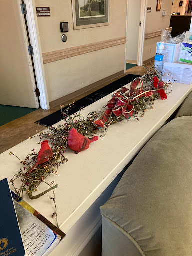 A beautifully arranged decorative piece featuring red flowers and natural stems, perfect for enhancing the ambiance of any gathering.