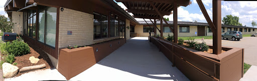 A well-lit outdoor walkway connected to a building, featuring modern architectural design.