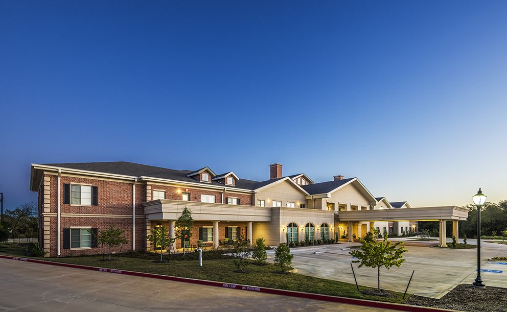 A modern residential building at sunset with clear skies.