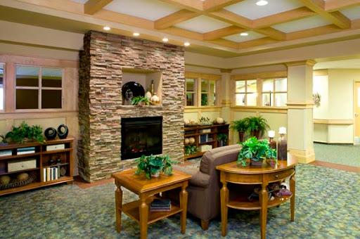 A cozy living room featuring a stone fireplace and inviting furniture.