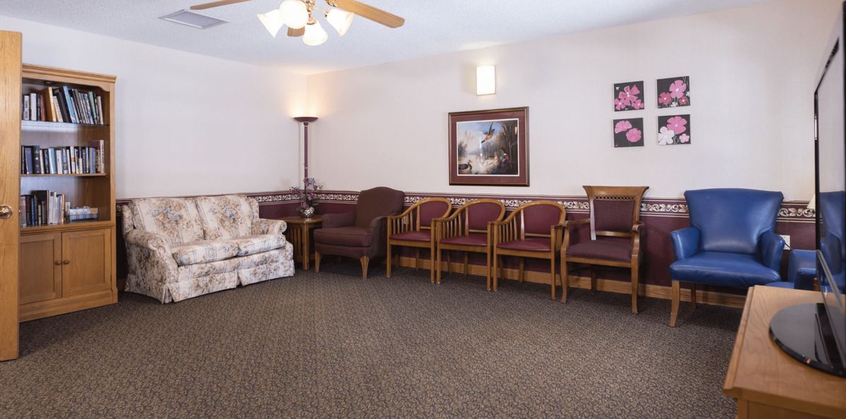 A waiting room with various seating options and decor.
