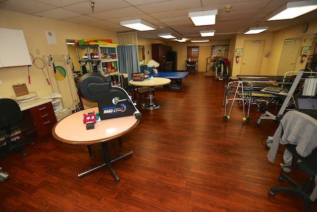 A rehabilitation room equipped with various therapy tools and equipment.
