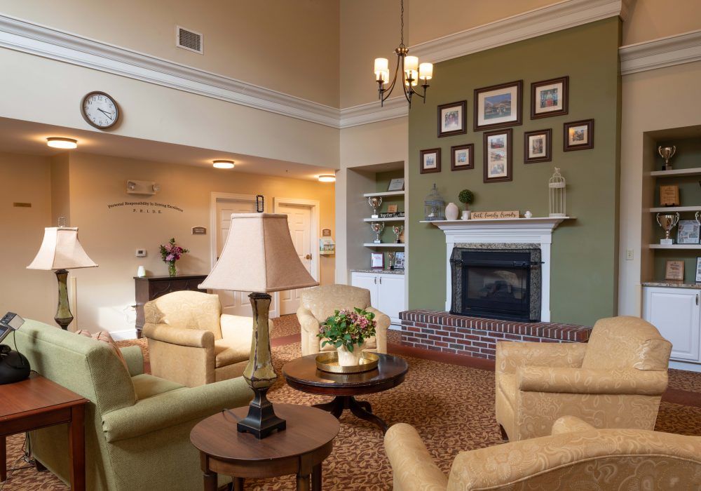 A cozy living room with comfortable seating and a decorated fireplace.