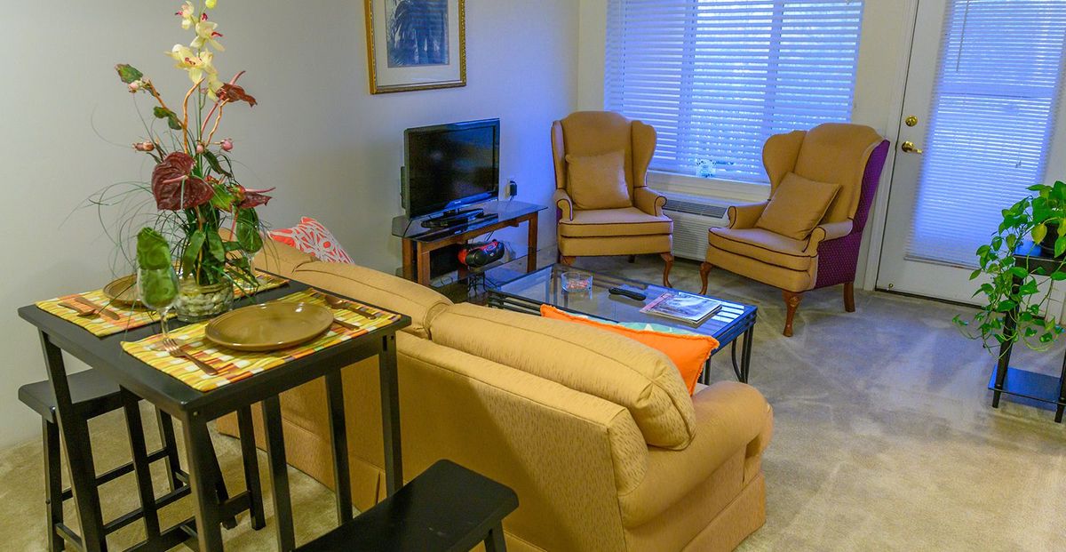A cozy living room with comfortable seating and a television.