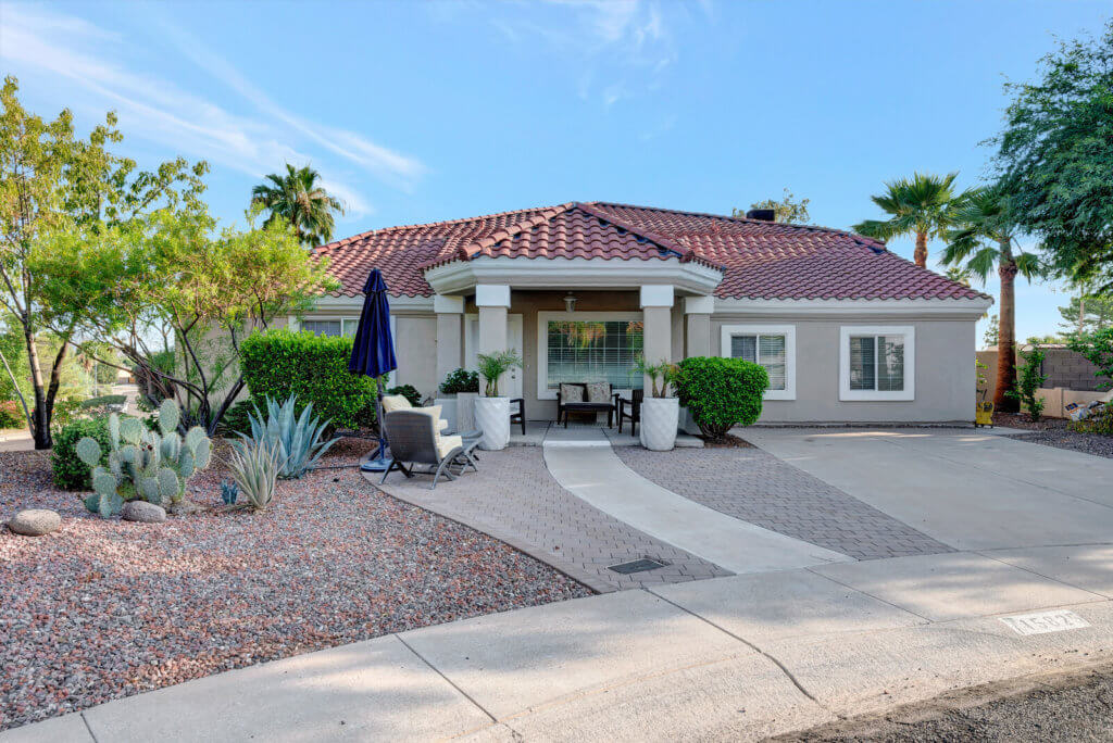 A beautiful single-story house with a landscaped front yard and a driveway.