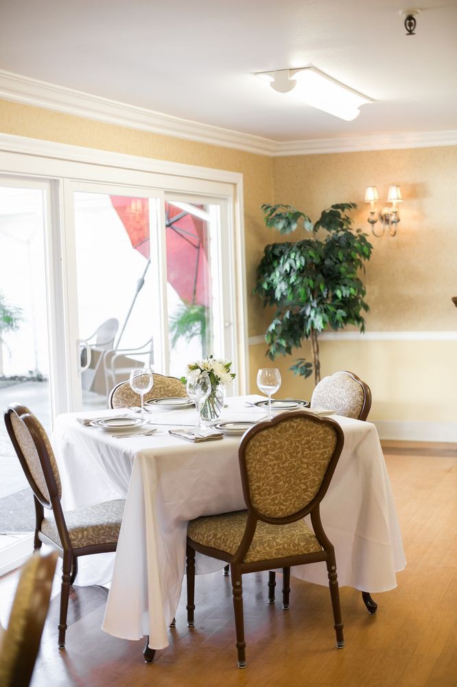 A beautifully set dining table in an elegant indoor setting with natural light and tasteful decor.