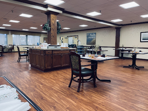 A spacious dining area featuring elegant wooden furniture and ample natural light.