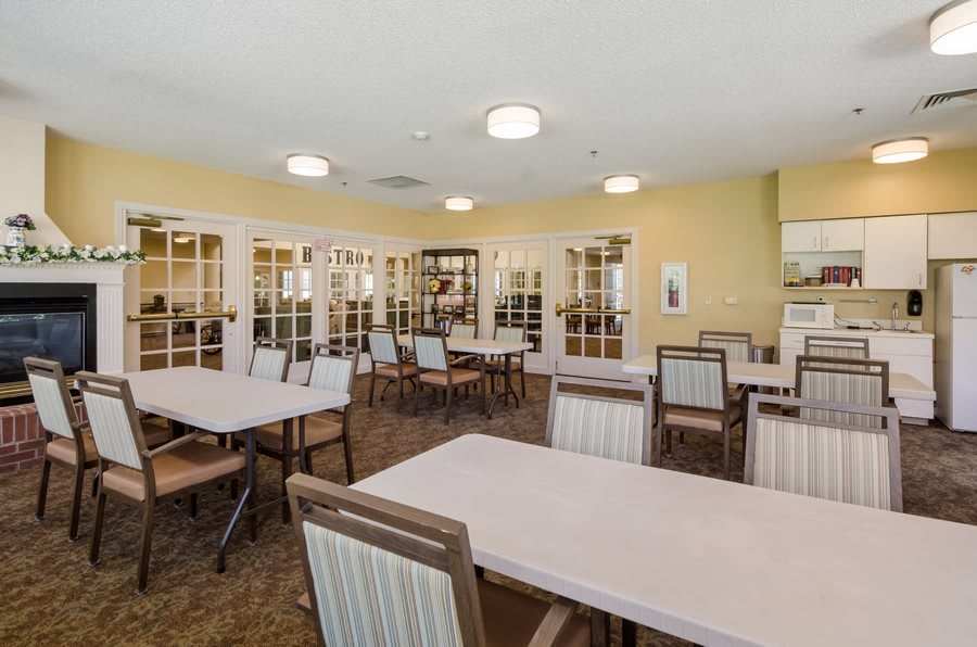 An interior view of a dining room with neatly arranged tables and chairs.