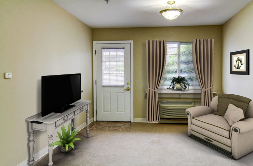 A cozy living room featuring a TV, sofa, and an indoor plant with natural light coming through the window.