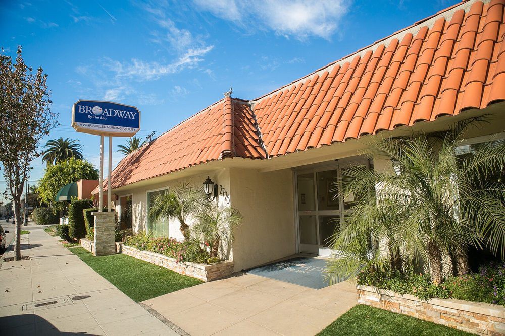 Exterior view of a hotel with a distinctive red-tiled roof and signage.
