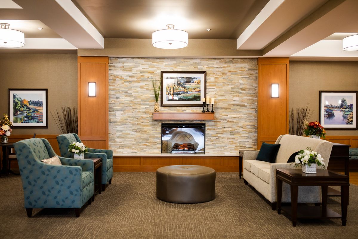 A modern lobby with comfortable seating and a cozy fireplace.