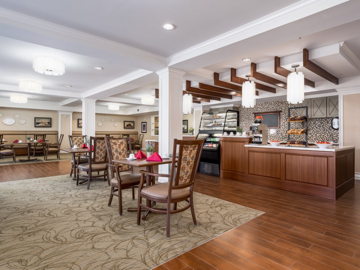 A cozy cafe interior with elegant furniture and ambient lighting.