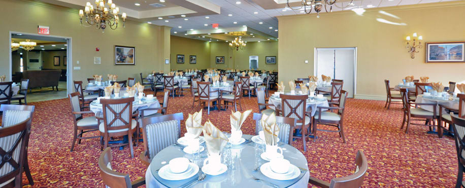 An elegant dining area with tables neatly set for guests.