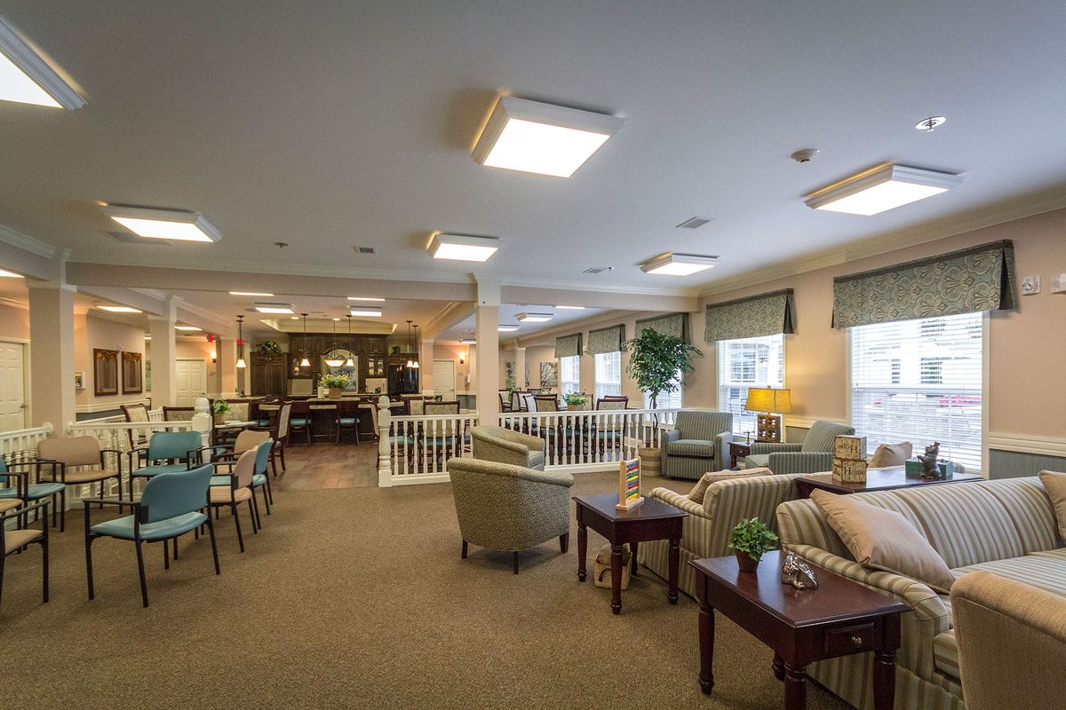 Spacious and well-lit lounge area with comfortable seating.