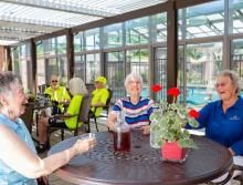 A group of people enjoying a relaxed social gathering on an outdoor patio.