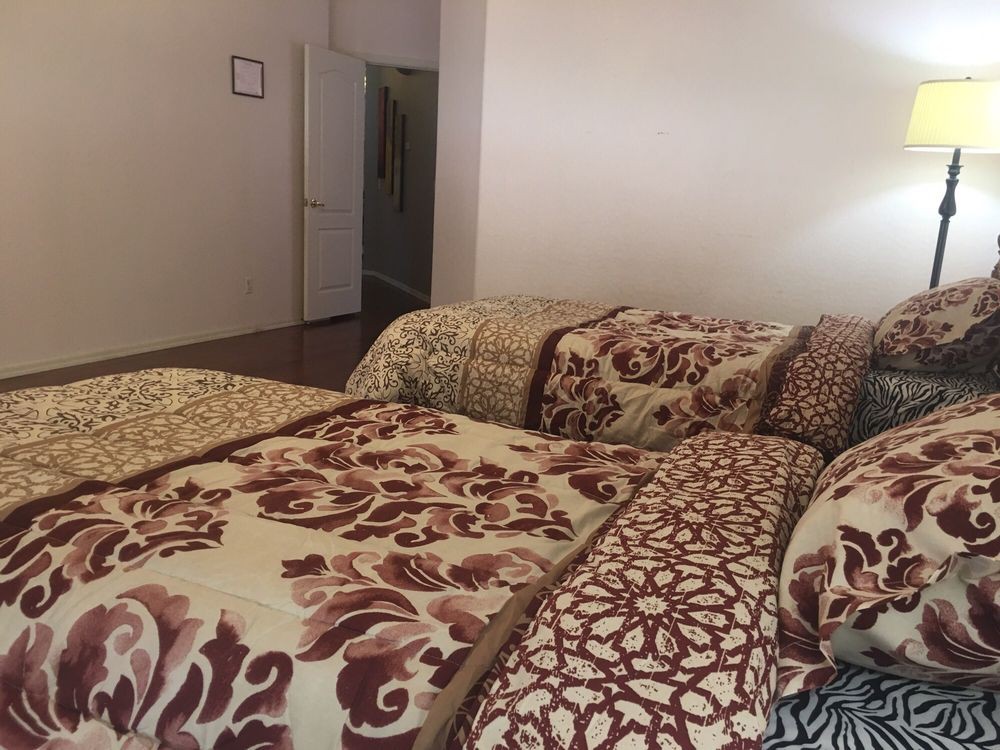 A cozy bedroom with patterned bedding and pillows.