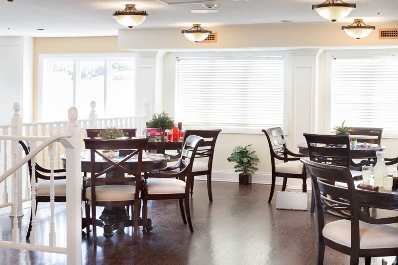 A well-lit dining room with elegant furniture and decor.