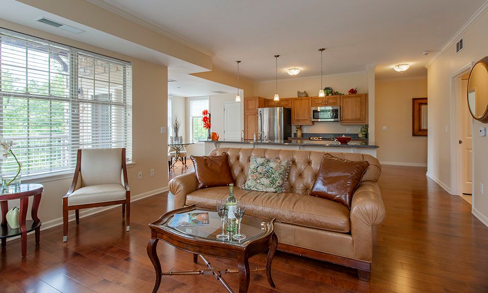 A modern open-concept living room and kitchen area with elegant furnishings.