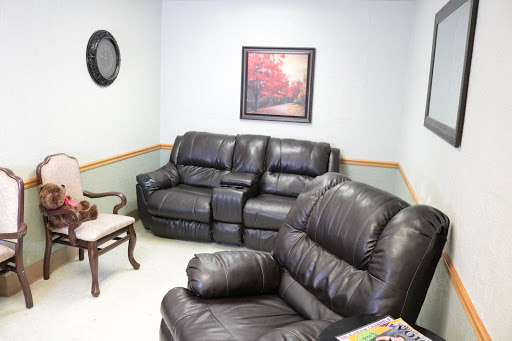 A cozy living room setup featuring leather furniture and decorative wall art.