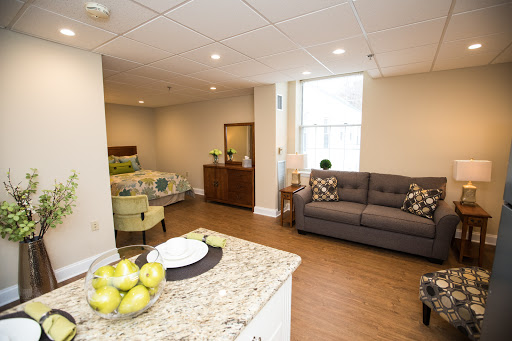 A modern and cozy apartment interior featuring a well-lit living area with stylish furniture.