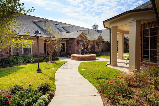 A serene courtyard with pathways and well-maintained gardens.