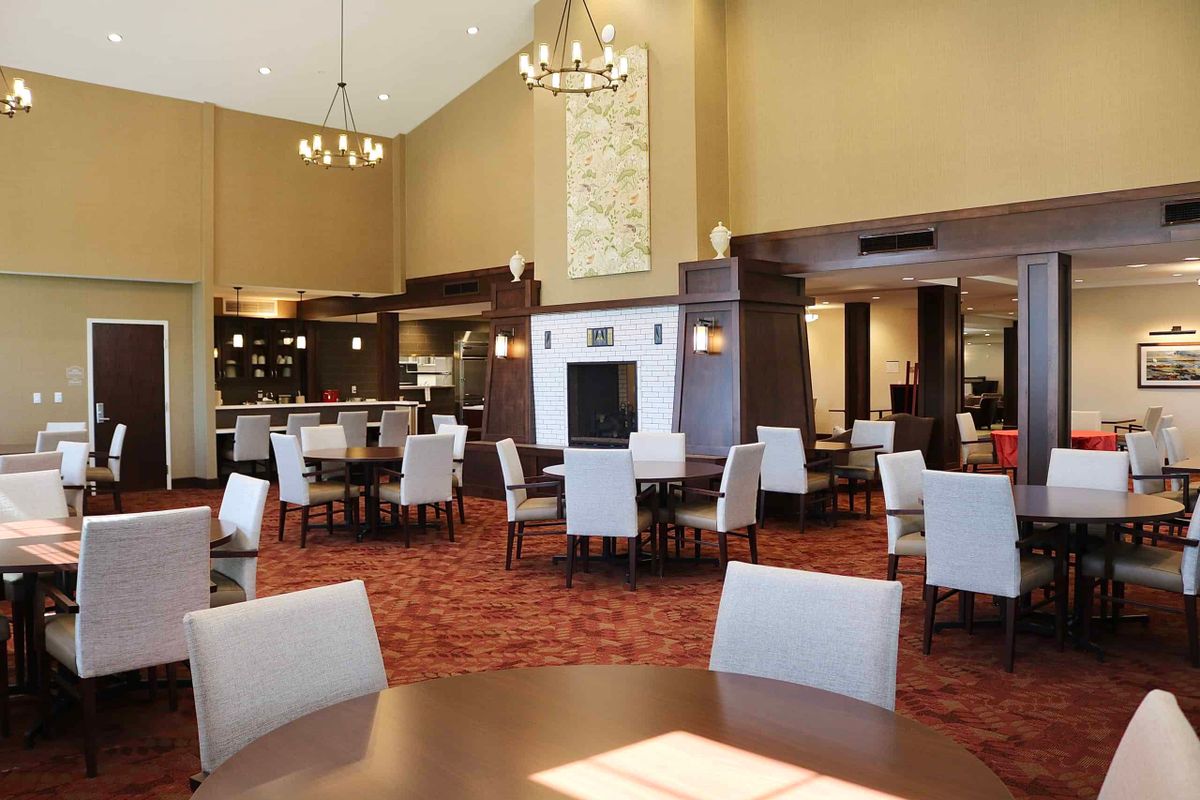 Spacious dining area with elegant chandeliers and comfortable seating.