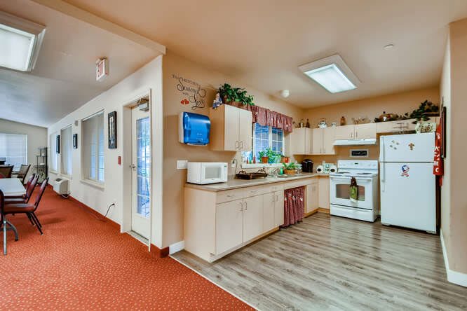 A cozy kitchen interior with modern appliances and wooden cabinetry.