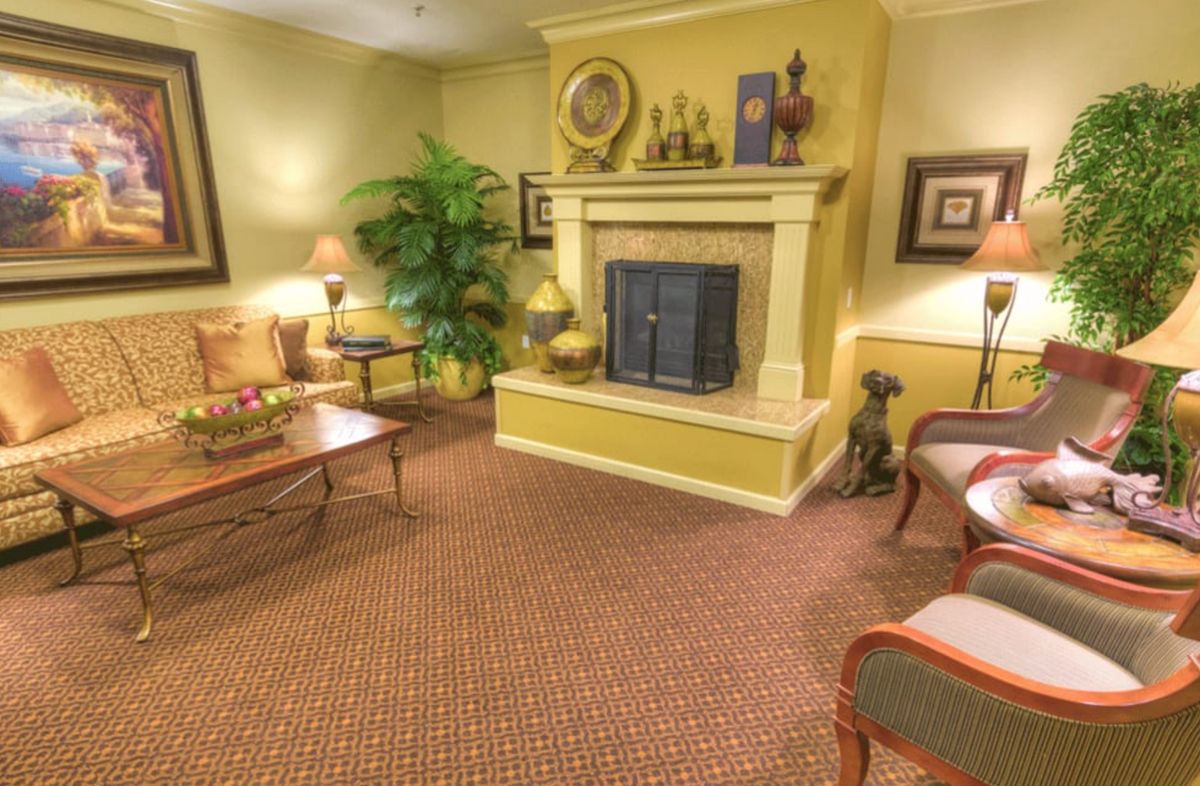 A cozy living room featuring a fireplace, comfortable seating, and warm decor.